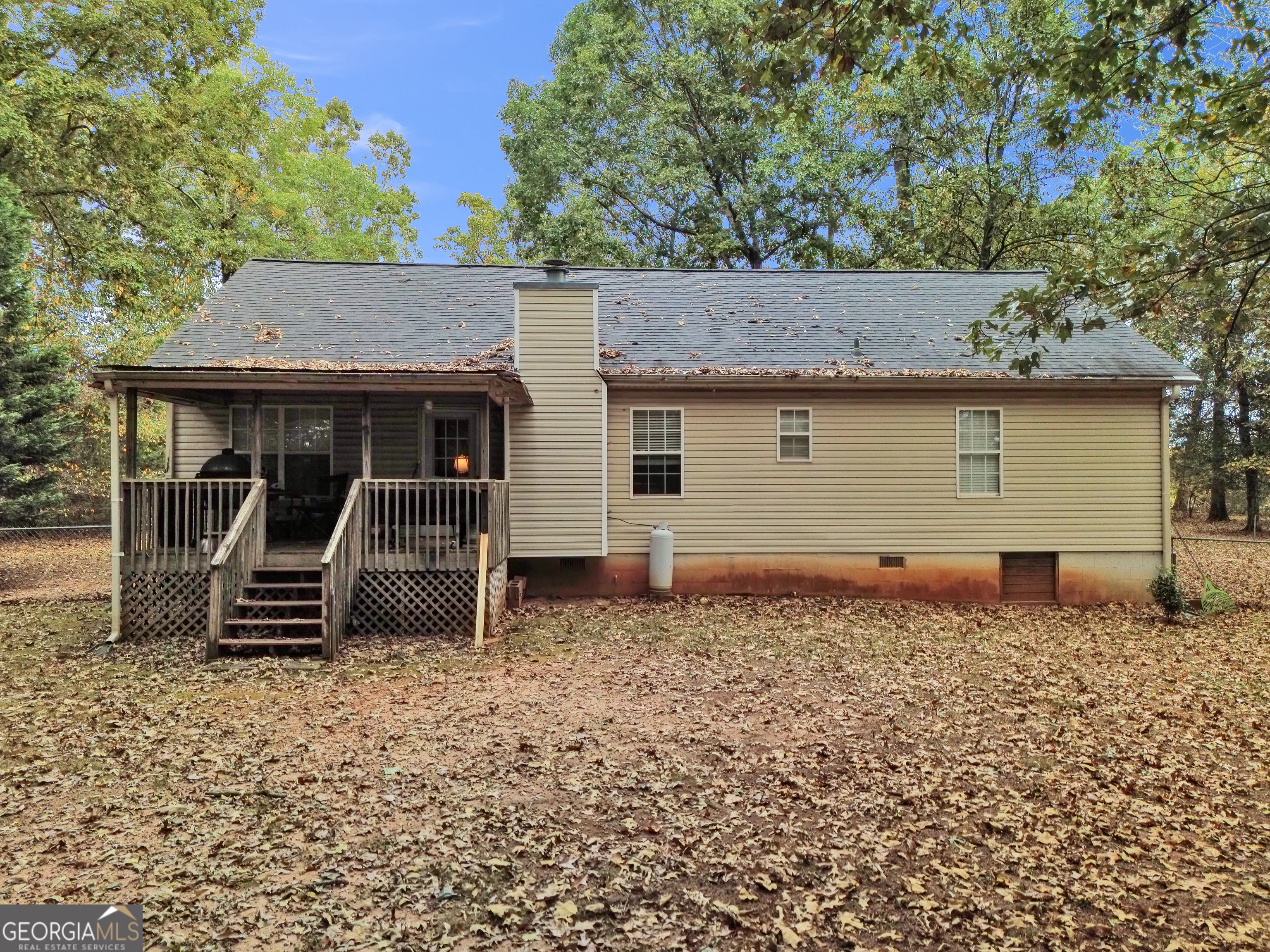 66 Ellis Trail Covington, GA 30016 - Photo 15 of 39 a backyard of a house with barbeque oven and wooden fence
