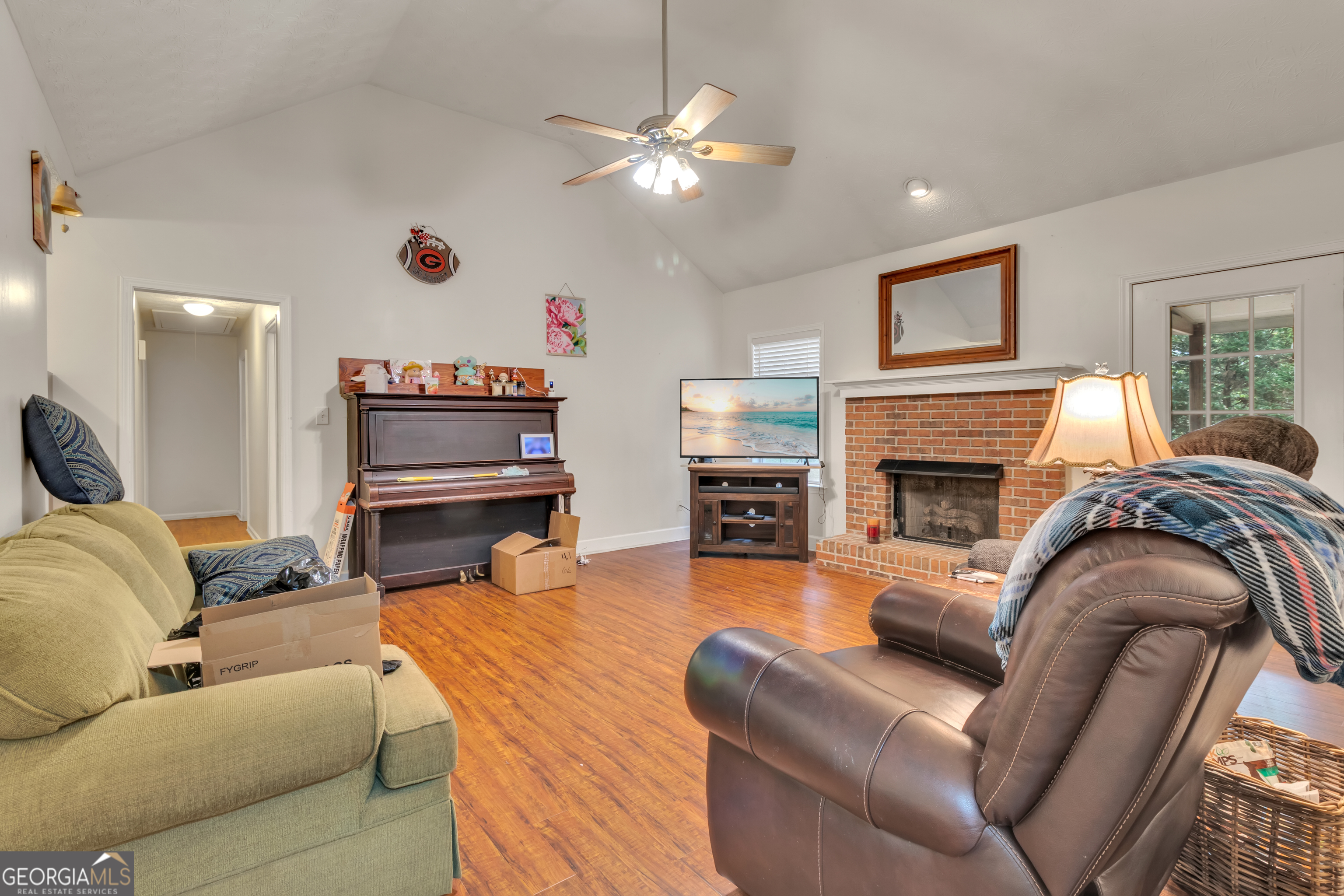 66 Ellis Trail Covington, GA 30016 - Photo 17 of 39 a living room with furniture a fireplace and a flat screen tv