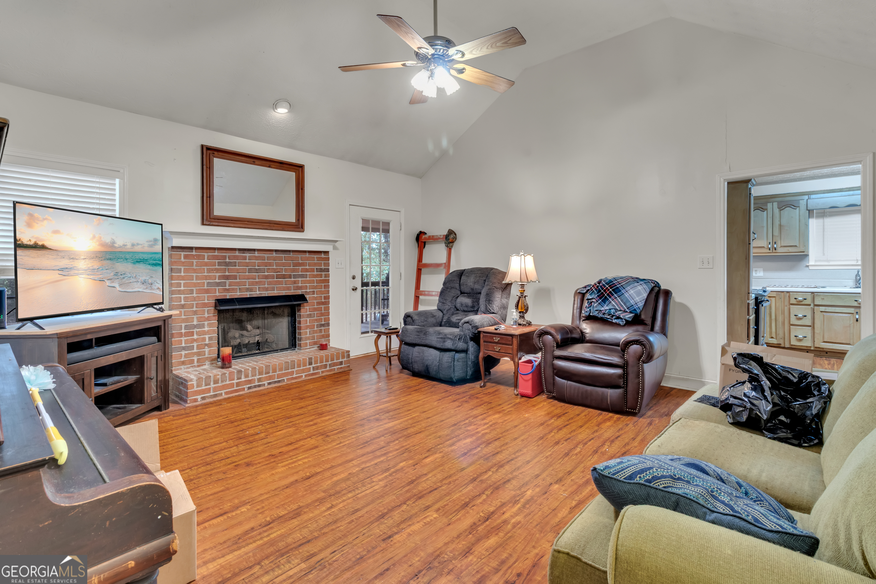 66 Ellis Trail Covington, GA 30016 - Photo 19 of 39 a living room with furniture a flat screen tv and a fireplace