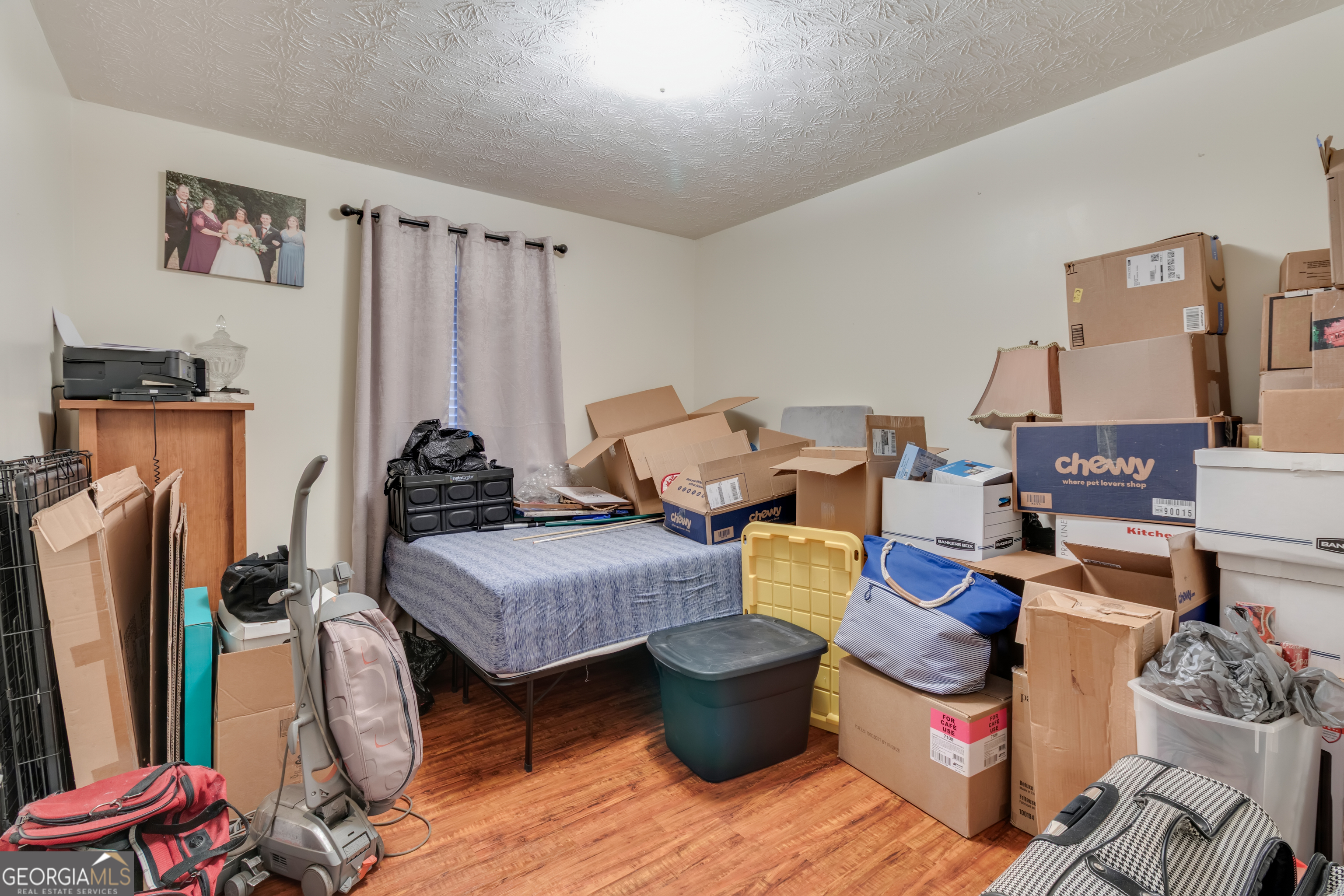 66 Ellis Trail Covington, GA 30016 - Photo 30 of 39 a living room with furniture a flat screen tv and a refrigerator