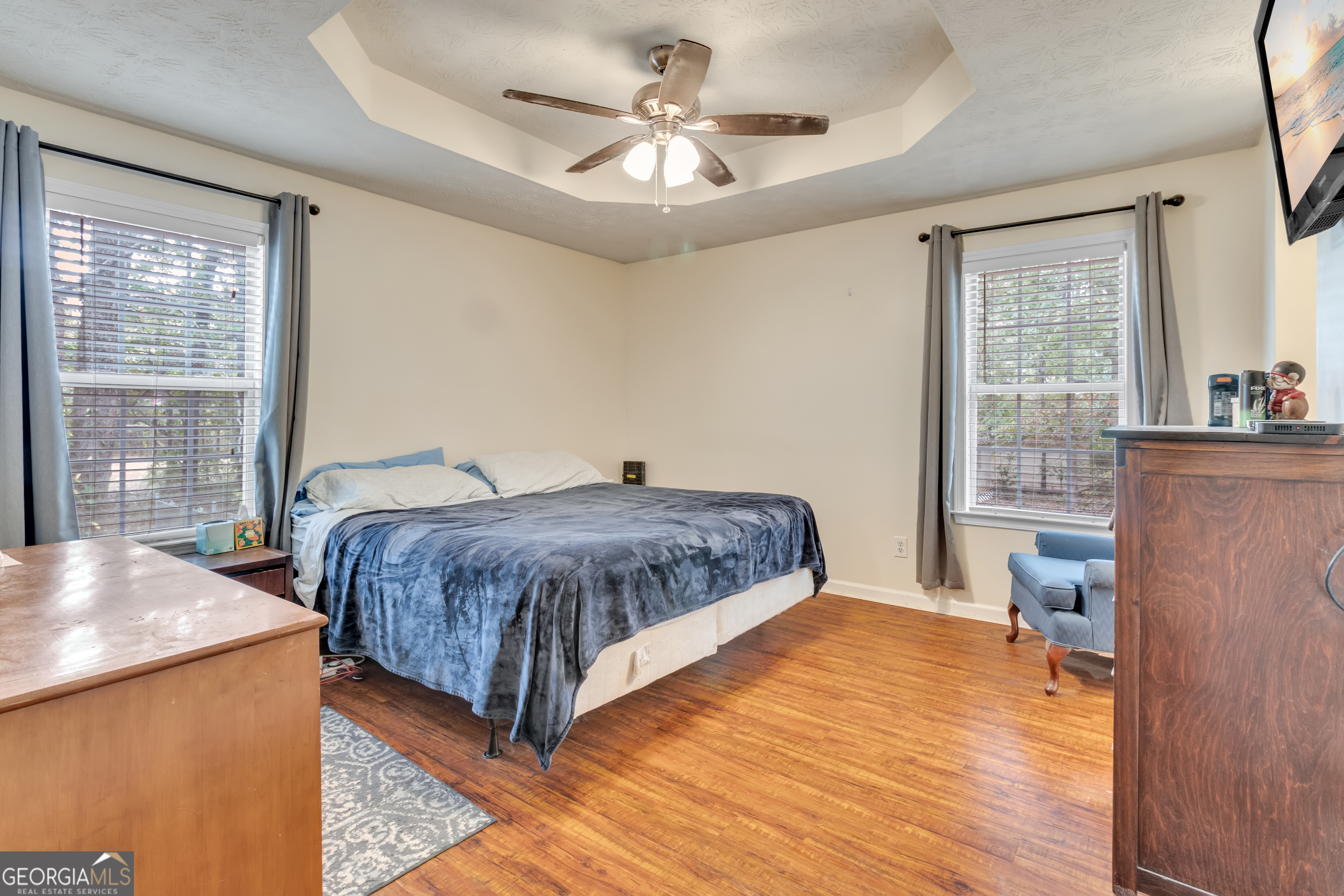 66 Ellis Trail Covington, GA 30016 - Photo 32 of 39 a spacious bedroom with a large bed a chandelier and windows