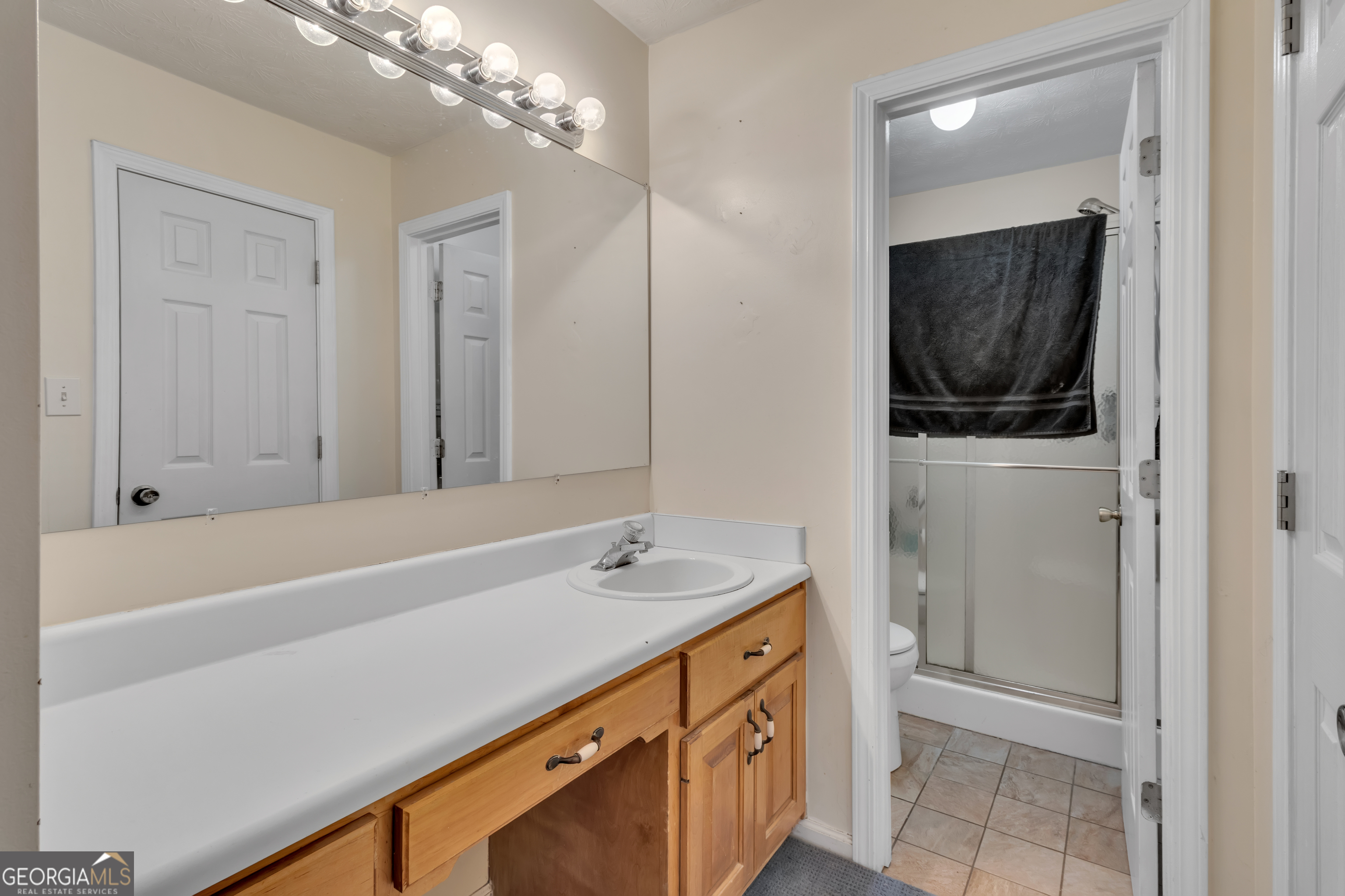 66 Ellis Trail Covington, GA 30016 - Photo 35 of 39 a bathroom with a sink a mirror and a bathtub