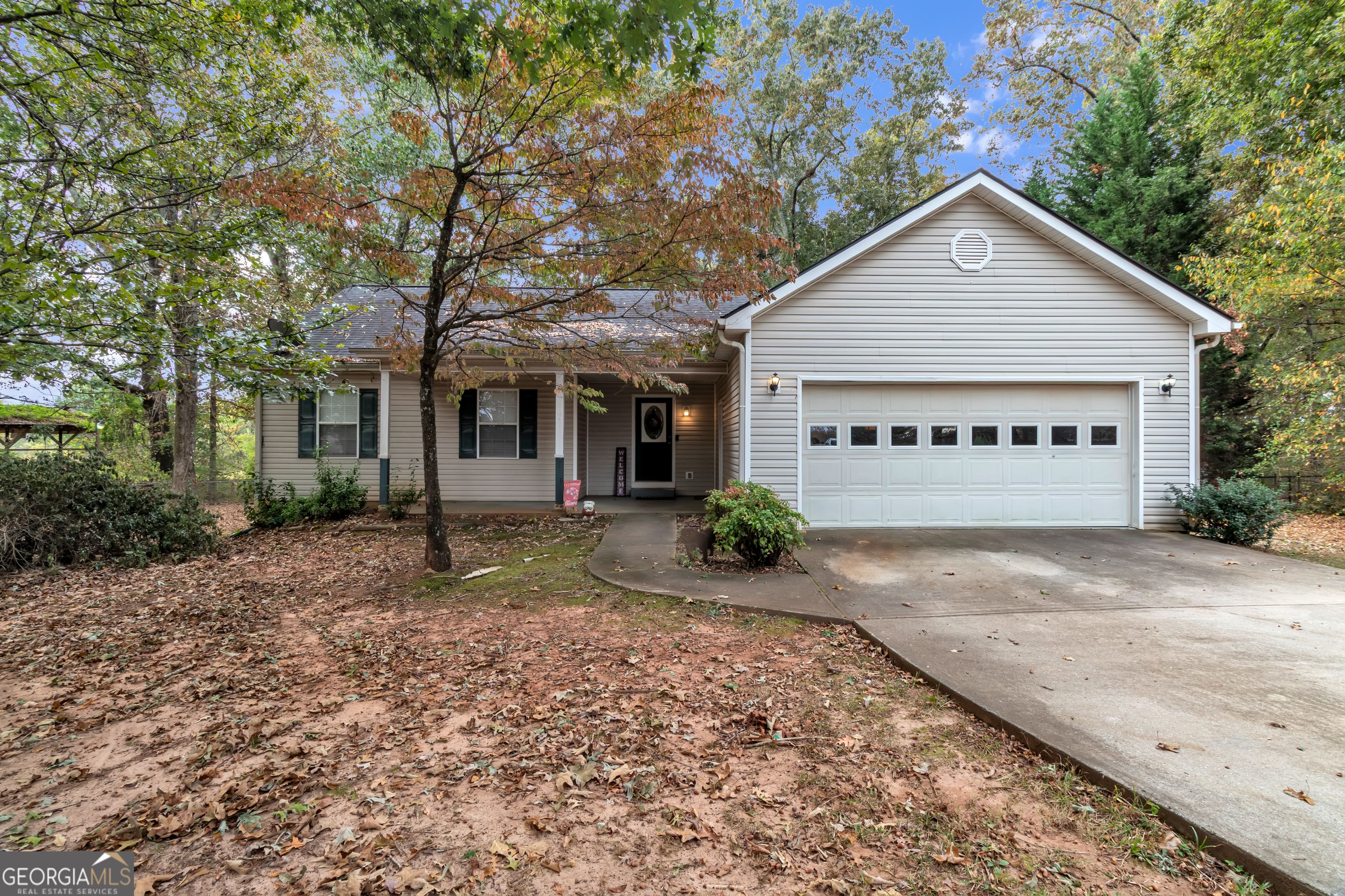 66 Ellis Trail Covington, GA 30016 - Photo 5 of 39 a view of a house with a yard plants and large tree