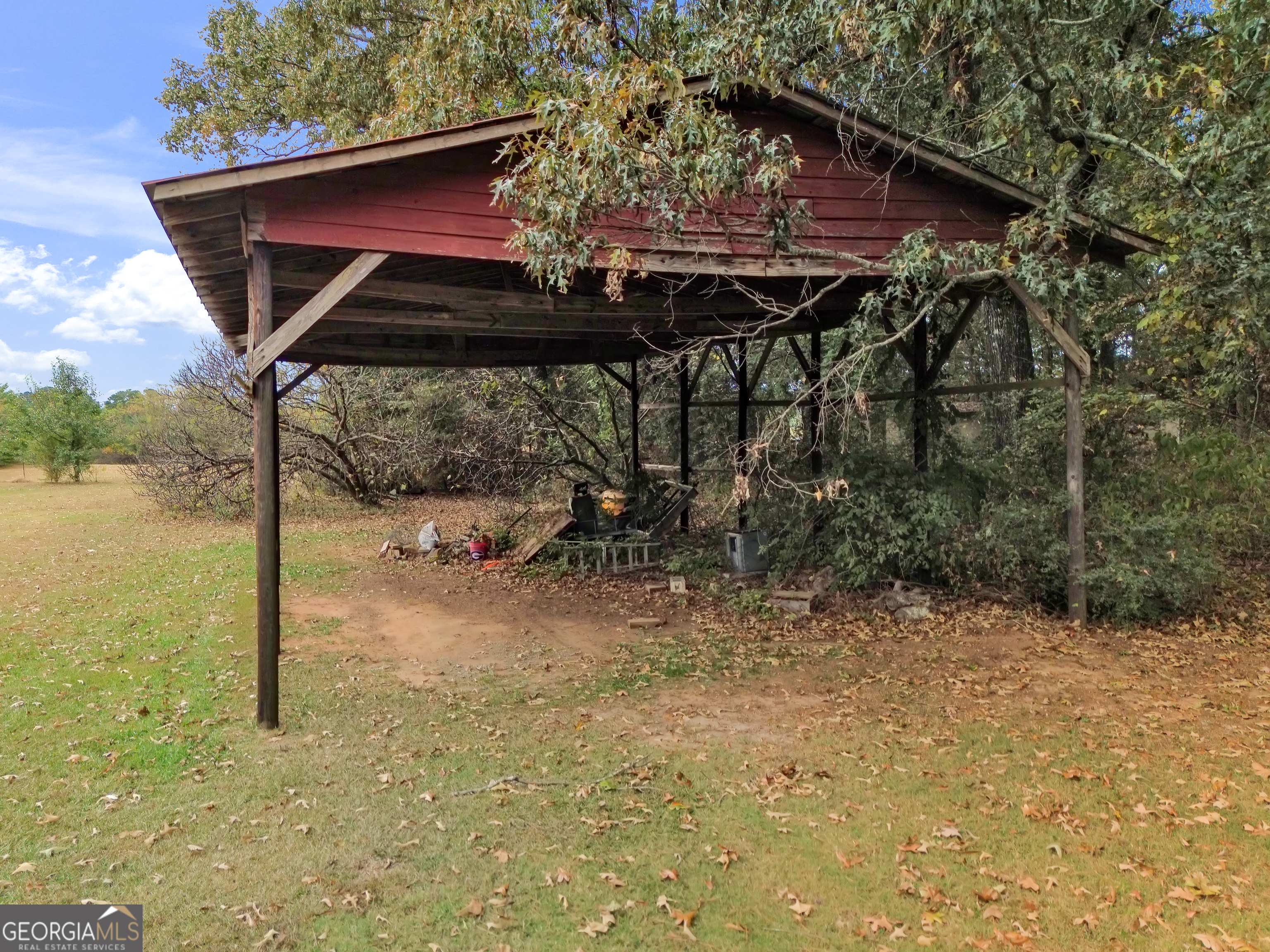 66 Ellis Trail Covington, GA 30016 - Photo 7 of 39 a backyard of a house with table and chairs under an umbrella