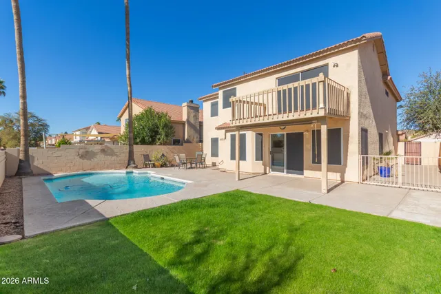 a view of a house with a yard and sitting area