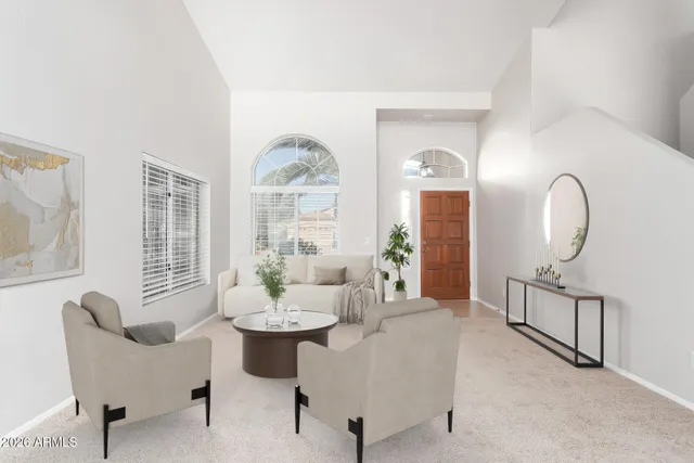 a living room with furniture chandelier and a large window