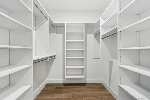 a view of walk in closet with empty racks