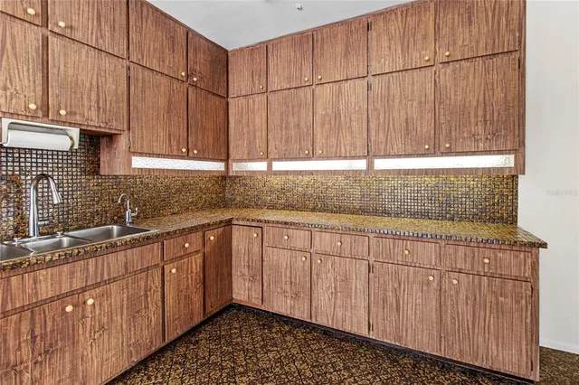 a kitchen with stainless steel appliances a refrigerator and a stove