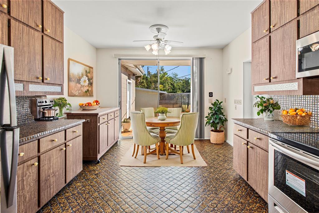 2605 Desoto Road Sarasota, FL 34243 - Photo 15 of 27 a dining room with stainless steel appliances a table and chair
