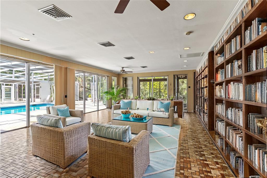 2605 Desoto Road Sarasota, FL 34243 - Photo 20 of 27 a living room with fireplace furniture and a book shelf