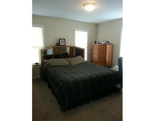 a bedroom with a bed and window