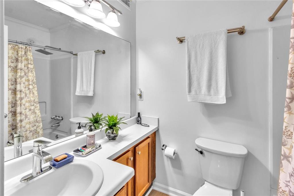 301 Cobblestone Trail Avondale Estates, GA 30002 - Photo 13 of 25 a bathroom with a sink a toilet and a mirror