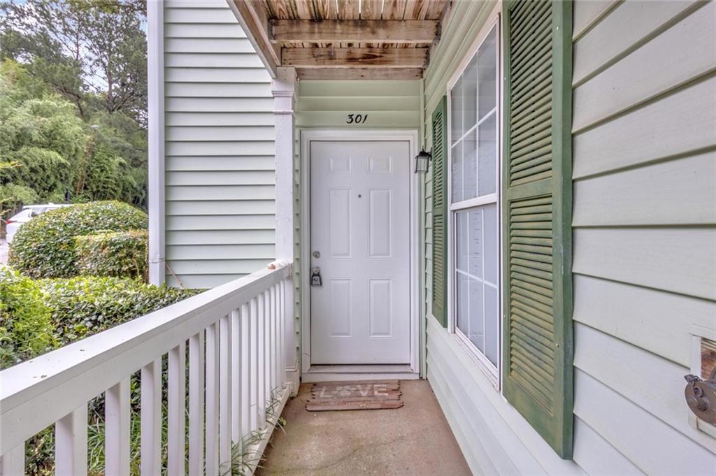 301 Cobblestone Trail Avondale Estates, GA 30002 - Photo 2 of 25 a view of a porch with a door and wooden floor
