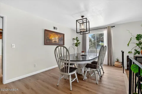 a view of a dining room with furniture window and wooden floor