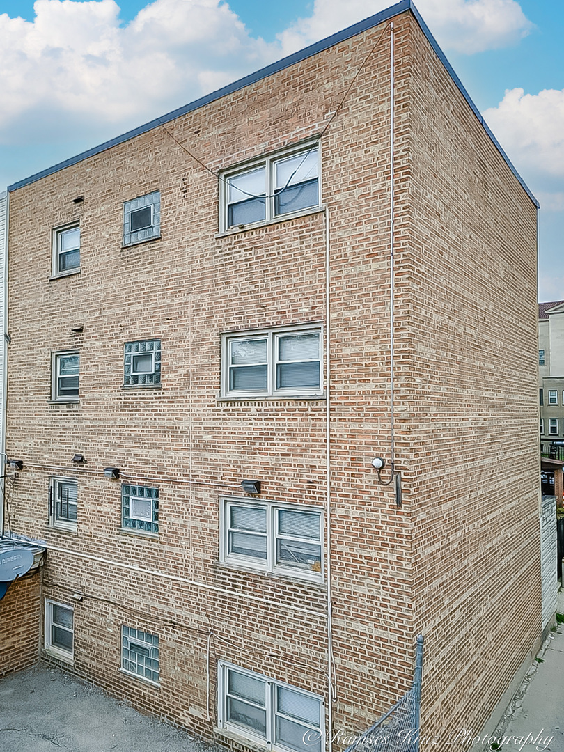 7844 South Jeffery Boulevard Chicago, IL 60649 - Photo 11 of 20 a brick building with a window and door