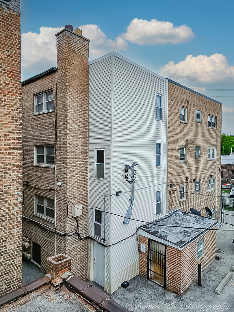 7844 South Jeffery Boulevard Chicago, IL 60649 - Photo 9 of 20 a buildings with couple of cars parked in front of it