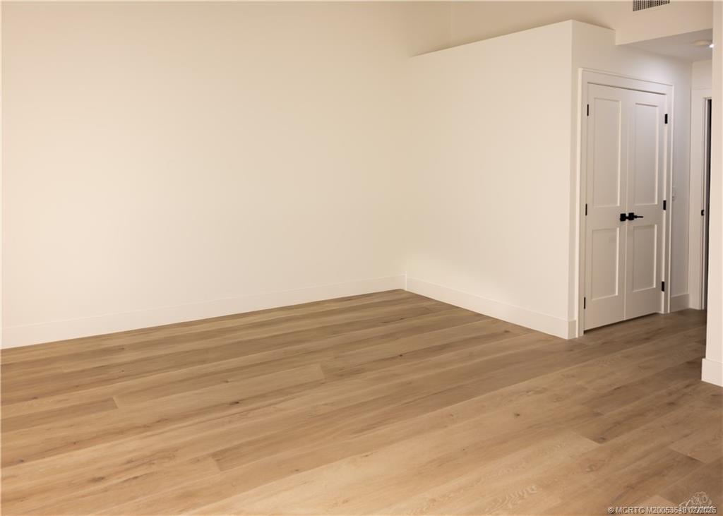 2425 Southwest Foxpoint Trail Palm City, FL 34990 - Photo 12 of 31 a view of empty room with wooden floor