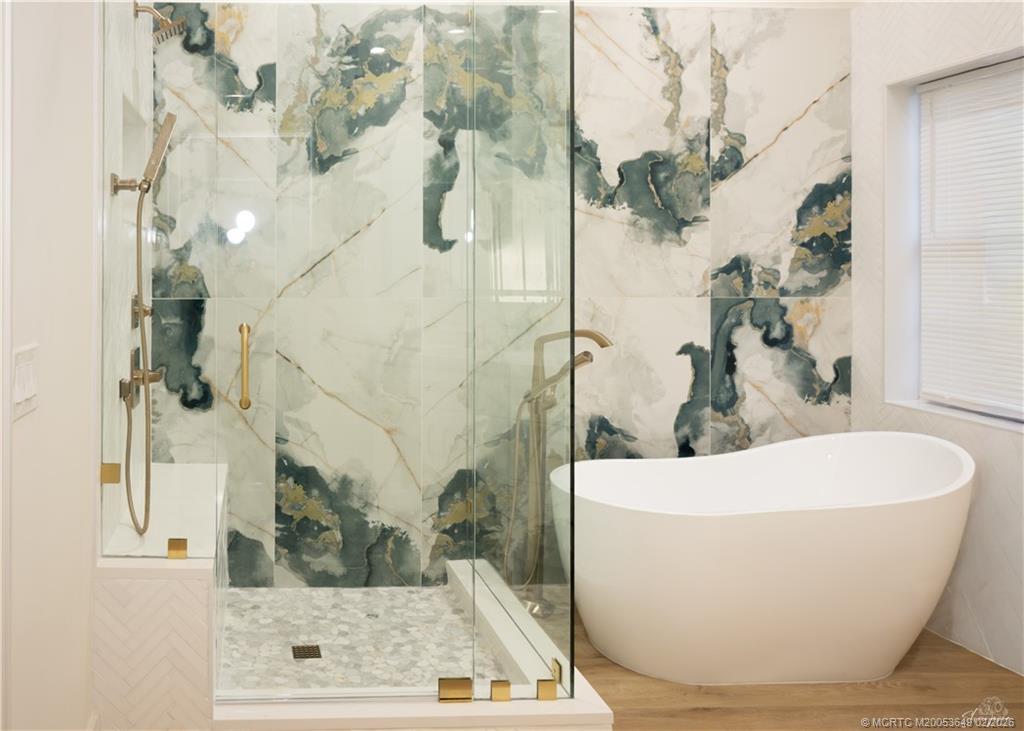 2425 Southwest Foxpoint Trail Palm City, FL 34990 - Photo 15 of 31 a white tub sitting next to a window