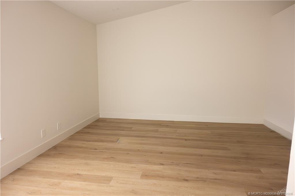 2425 Southwest Foxpoint Trail Palm City, FL 34990 - Photo 18 of 33 a view of an empty room with wooden floor