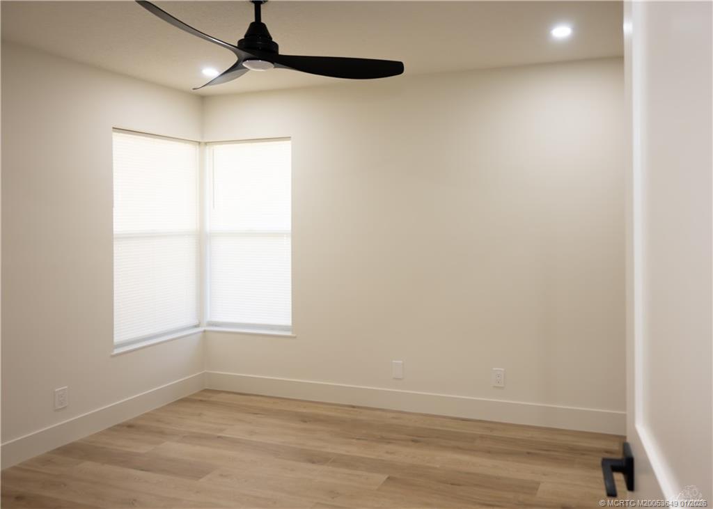 2425 Southwest Foxpoint Trail Palm City, FL 34990 - Photo 22 of 33 an empty room with a window and a ceiling fan