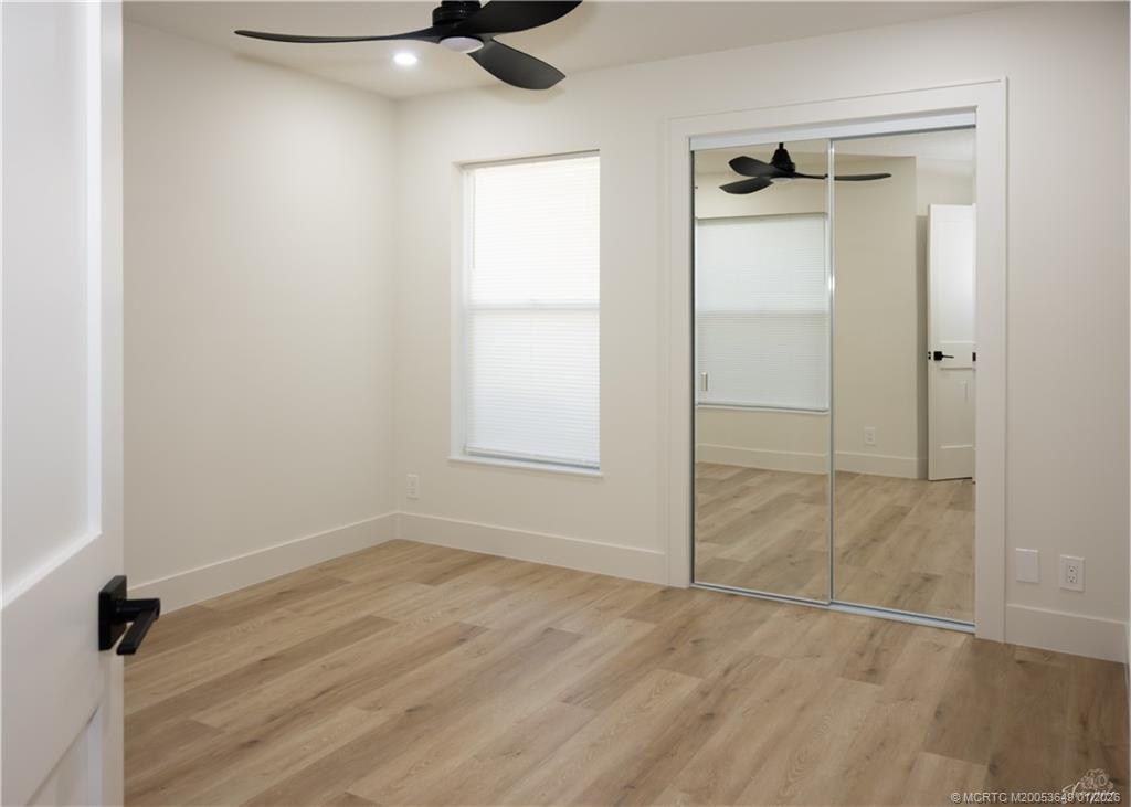 2425 Southwest Foxpoint Trail Palm City, FL 34990 - Photo 23 of 33 an empty room with a cabinet and mirrors