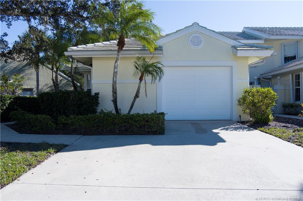2425 Southwest Foxpoint Trail Palm City, FL 34990 - Photo 29 of 33 a front view of a house with garden