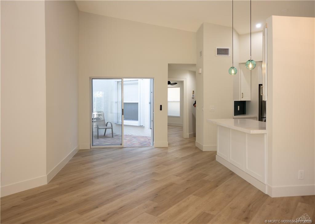 2425 Southwest Foxpoint Trail Palm City, FL 34990 - Photo 6 of 33 a view of a hallway with bathroom and wooden floor