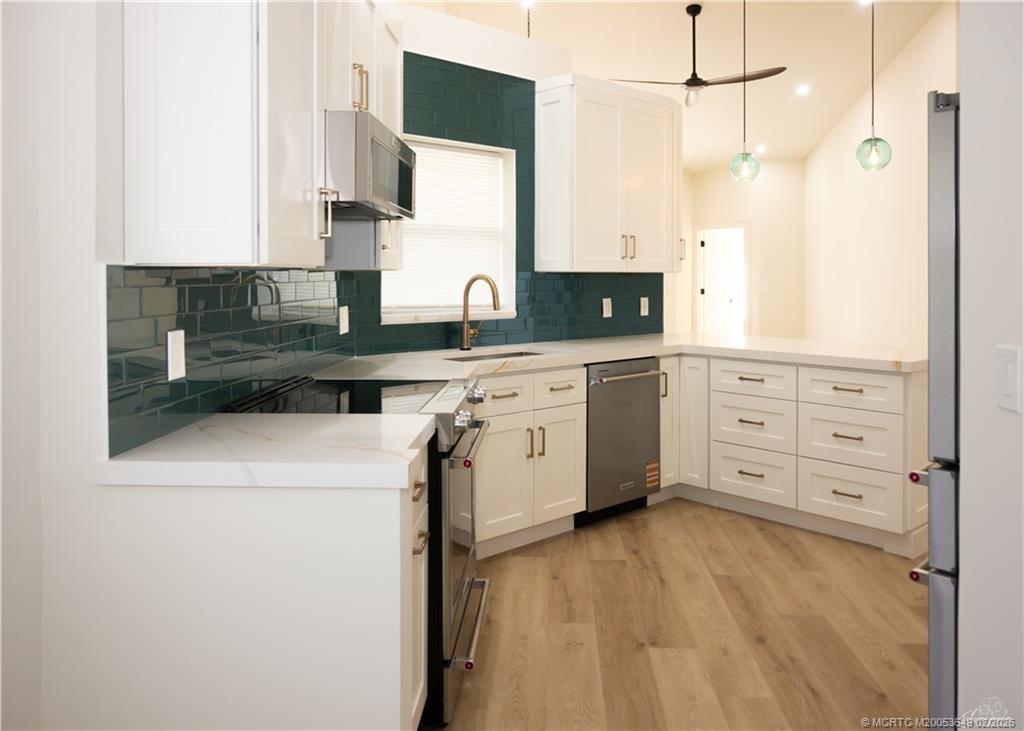2425 Southwest Foxpoint Trail Palm City, FL 34990 - Photo 7 of 31 a kitchen with a cabinets and appliances