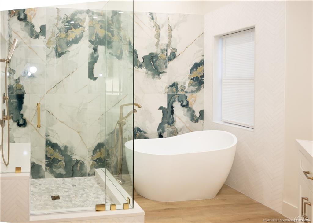 2425 Southwest Foxpoint Trail Palm City, FL 34990 - Photo 8 of 33 a white tub sitting next to a bathroom sink