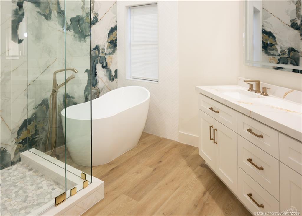 2425 Southwest Foxpoint Trail Palm City, FL 34990 - Photo 9 of 33 a bathroom with a tub sink and mirror