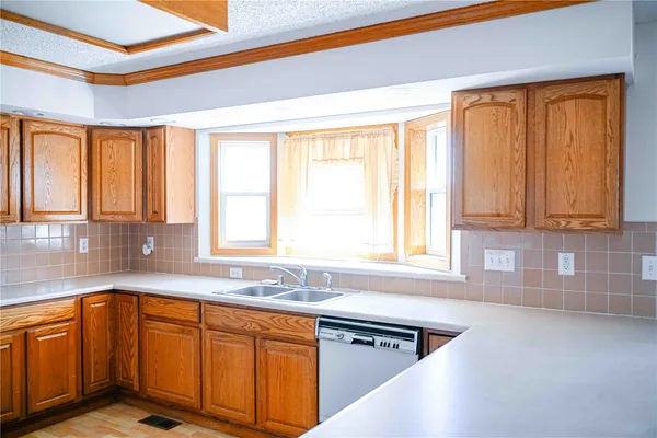 a kitchen with stainless steel appliances a stove a sink and a refrigerator
