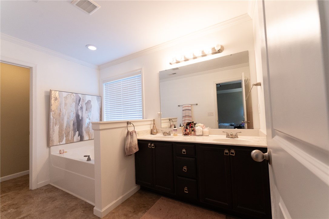 1012 Whirlaway Circle Anderson, SC 29621 - Photo 13 of 25 Indulge in this primary bathroom featuring a spacious soaking tub and a generous dual vanity.