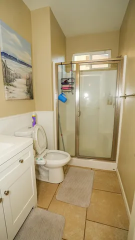 a bathroom with a shower a toilet and a shower