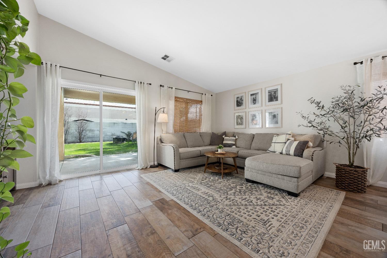 Undisclosed Address Bakersfield, CA 93311 - Photo 11 of 30 a living room with furniture and a floor to ceiling window