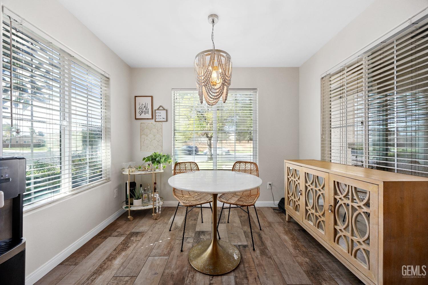 Undisclosed Address Bakersfield, CA 93311 - Photo 17 of 30 a dining room with chandelier windows and wooden floor