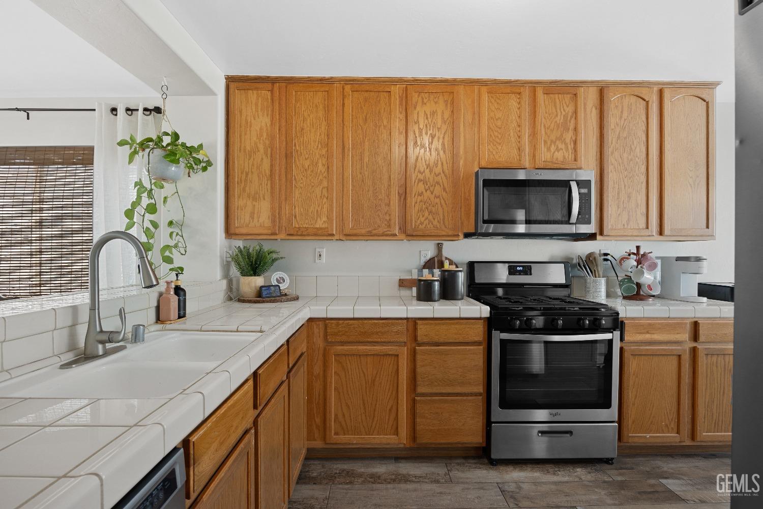 Undisclosed Address Bakersfield, CA 93311 - Photo 18 of 30 a kitchen with a sink stove and microwave