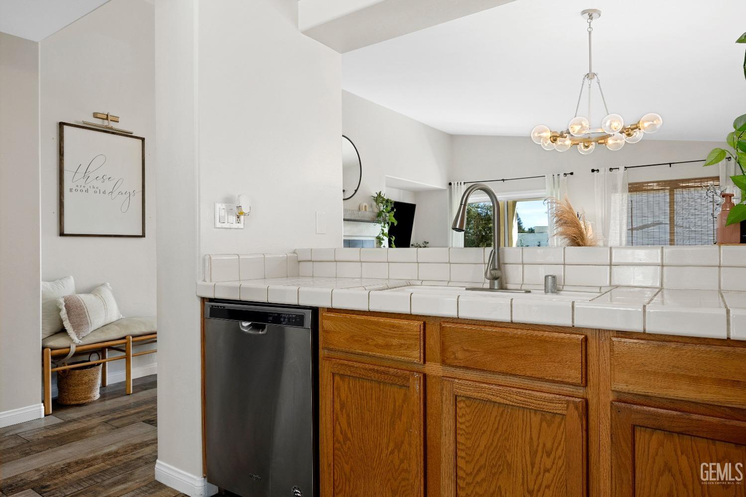 Undisclosed Address Bakersfield, CA 93311 - Photo 19 of 30 a view of center kitchen island a sink wooden floor and living room view