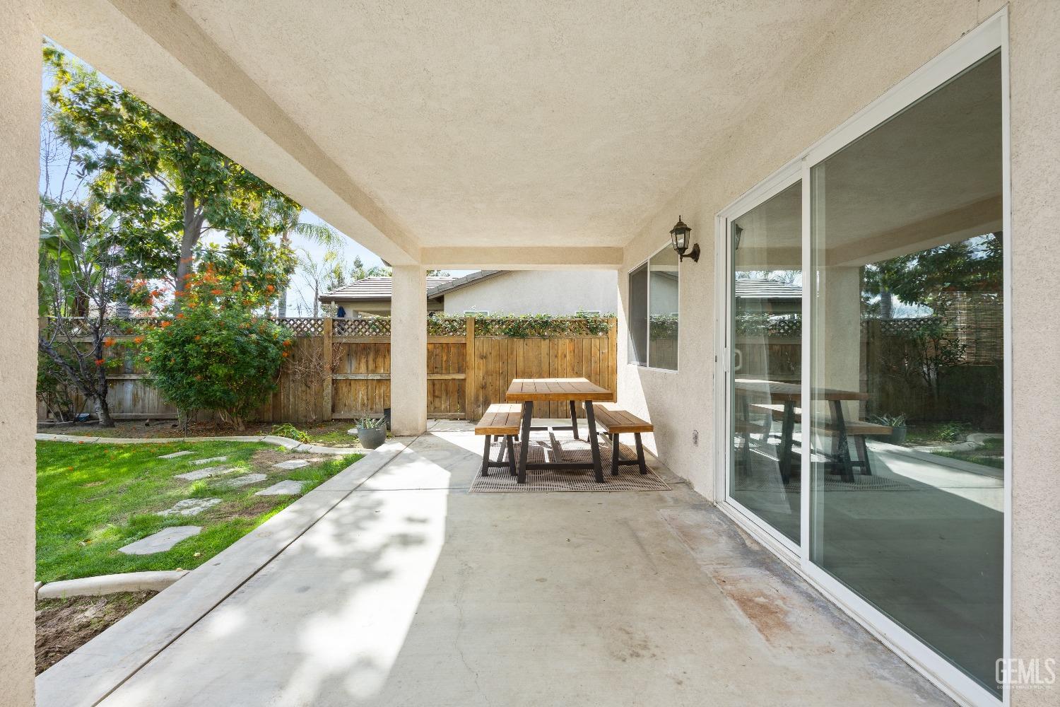 Undisclosed Address Bakersfield, CA 93311 - Photo 29 of 30 a living room with yard floor to ceiling window and wooden floor