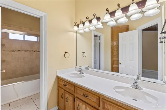 a bathroom with a double vanity sink mirror and shower