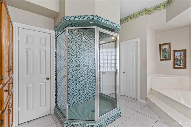 a view of a bathroom with a glass door shower