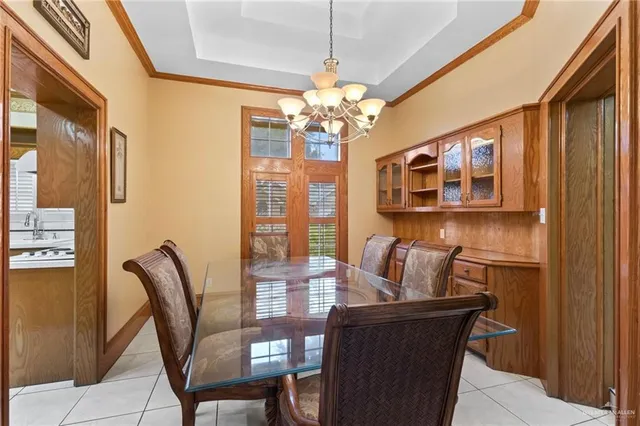 a dining room with furniture and chandelier