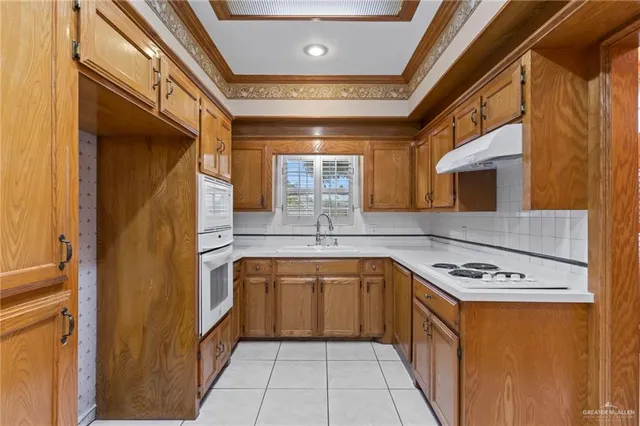 a kitchen with stainless steel appliances a sink stove and cabinets
