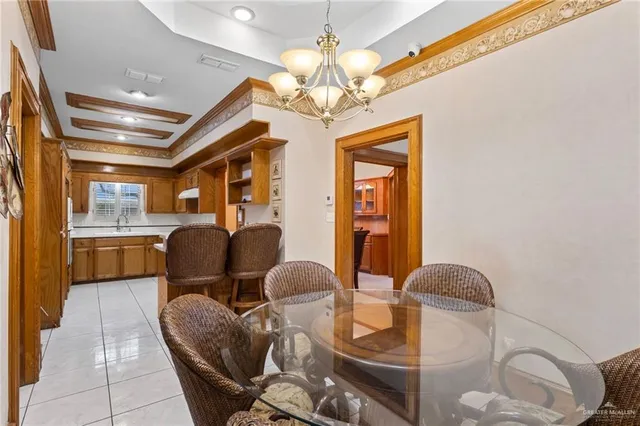 a dining room with furniture a chandelier and wooden floor