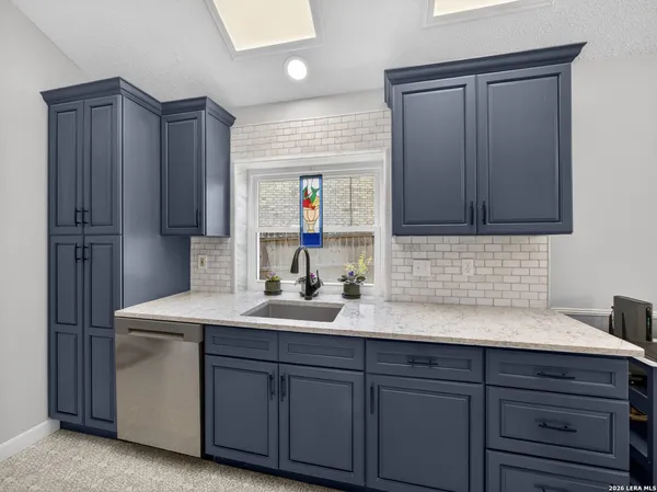 a kitchen with a sink and cabinets