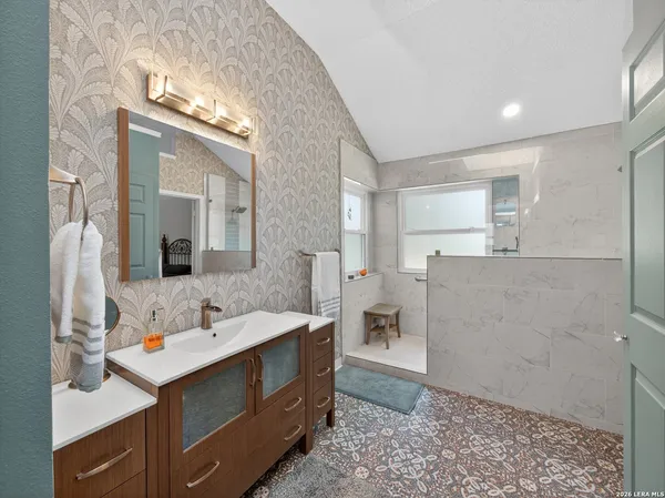 a bathroom with a shower and a sink
