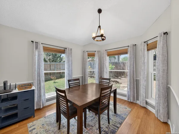 a view of a dining room with furniture window and wooden floor