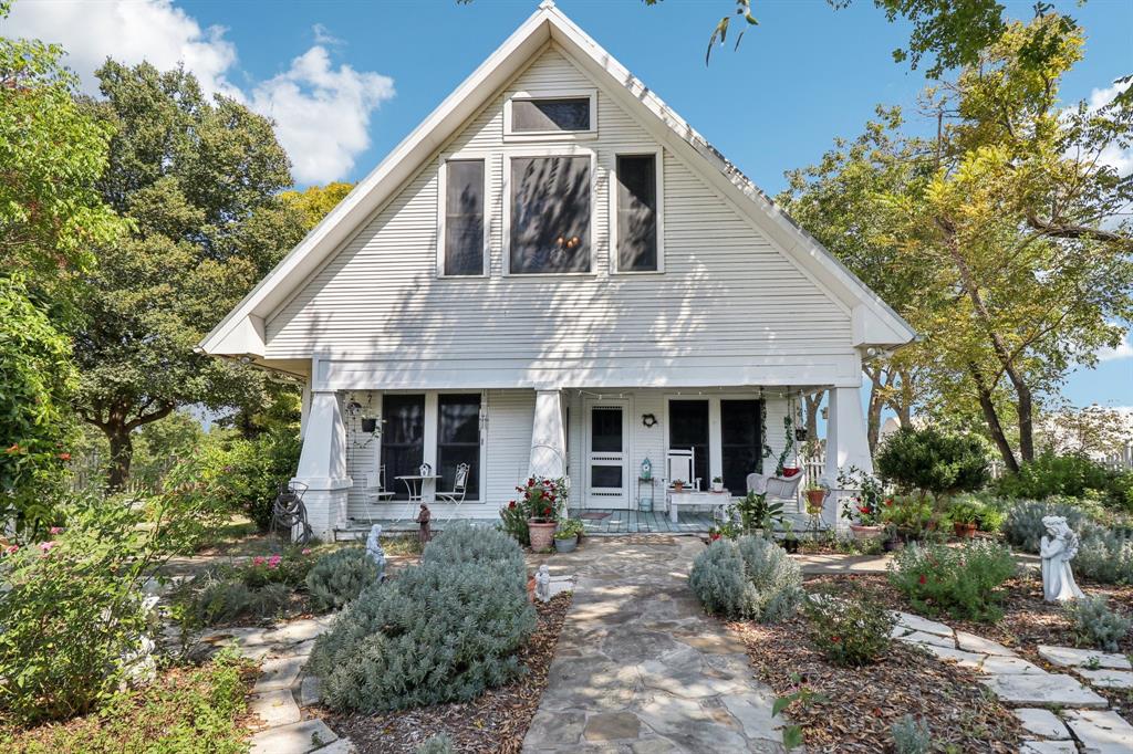 a front view of house with outdoor seating and yard