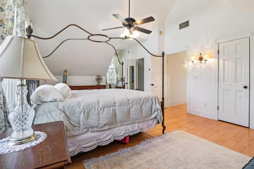 1590 Airport Road Aledo, TX 76008 - Photo 14 of 26 a bedroom with a bed a chandelier and dresser