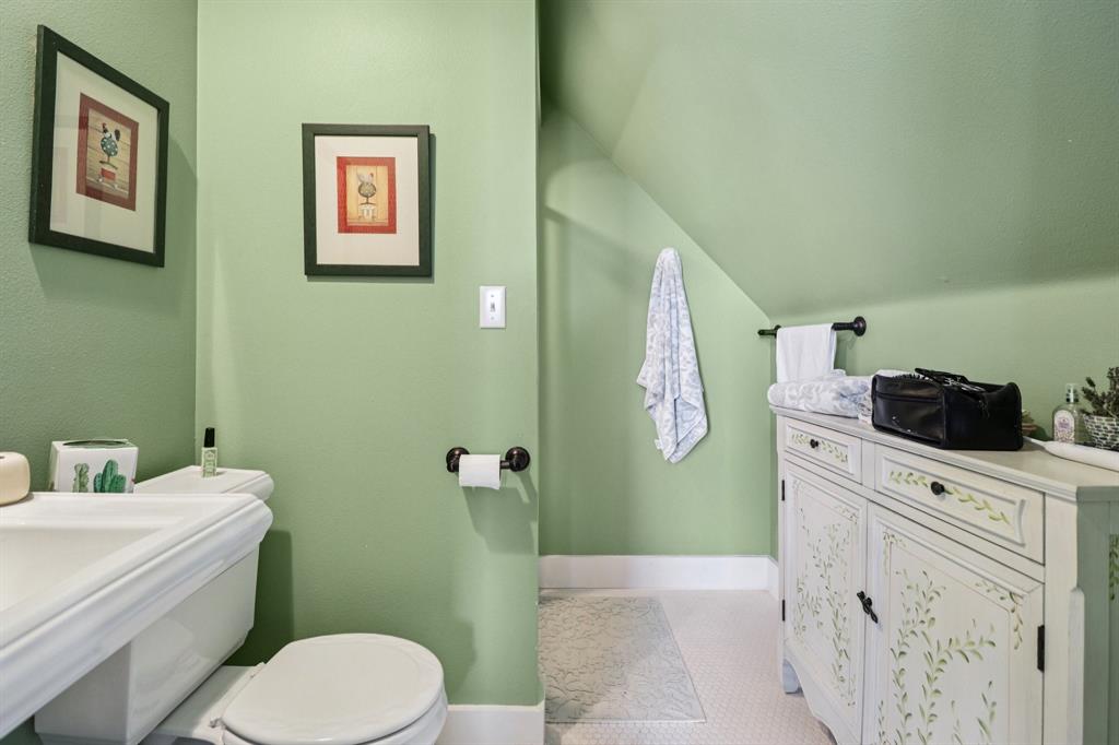 1590 Airport Road Aledo, TX 76008 - Photo 19 of 26 a bathroom with a toilet sink and mirror