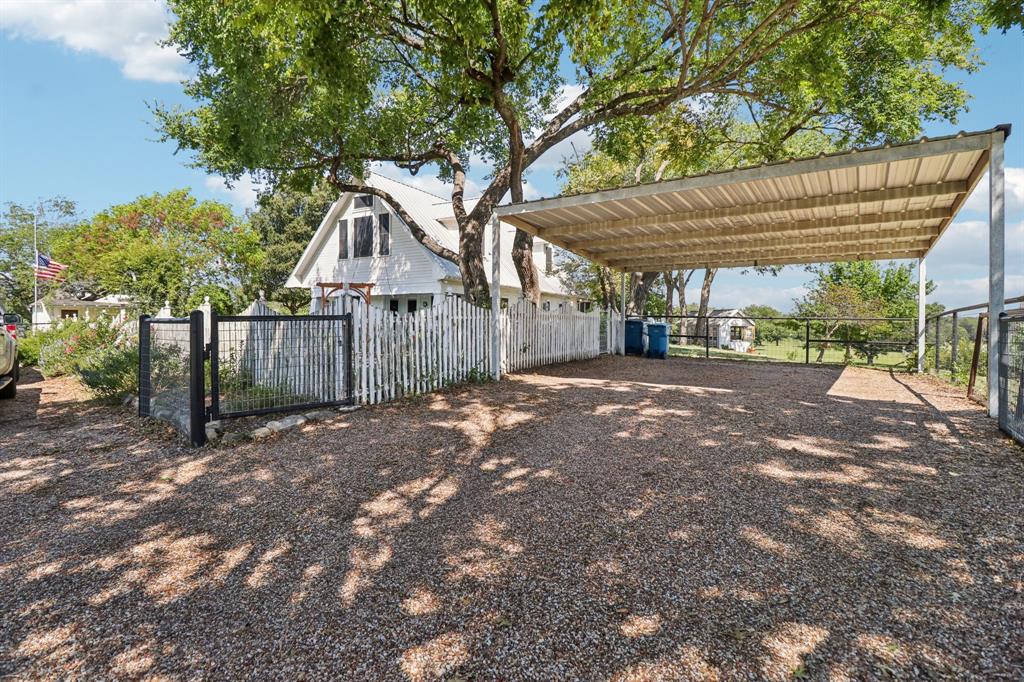 1590 Airport Road Aledo, TX 76008 - Photo 3 of 26 a view of a house with a small yard and a large tree